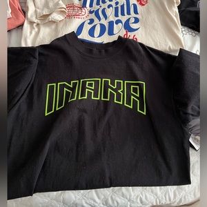 Black and green Inaka power tee and smiley Inaka tee